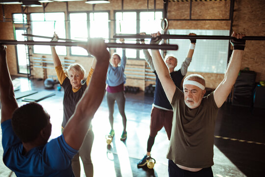 Senior Fitness Class Lifting Weights Together