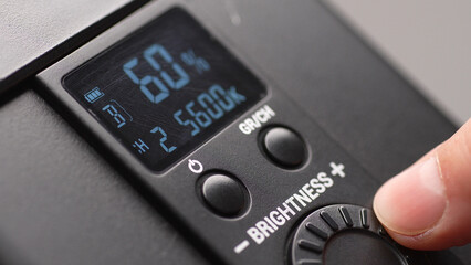 Adjusting Light Intensity on Digital Control Panel. Close-up, shallow dof.