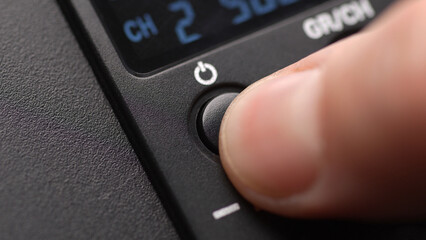 Pressing Power Button on Digital Device. Close-up, shallow dof.