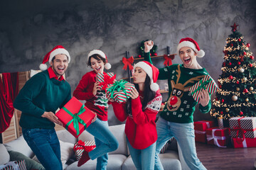 Portrait of positive carefree fellows hold christmas time giftbox dancing decorated living room house indoors - obrazy, fototapety, plakaty
