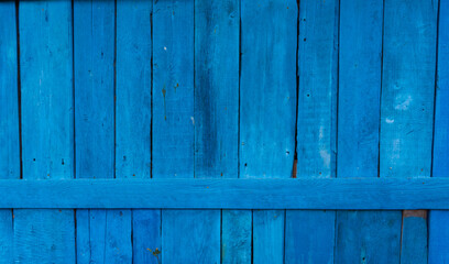 Close-up, vertical blue wooden planks. Detailed texture of the fence
