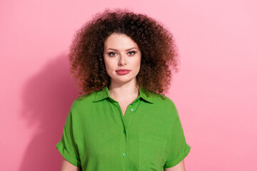 Photo of serious confident young lady wear green shirt looking you isolated pink color background