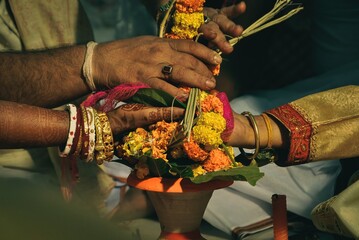 Bengali wedding rituals bride and groom holding hand.