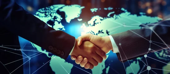 Fotobehang Closeup Businessmen handshake on digital global market graph bar chart diagram background. © artpray