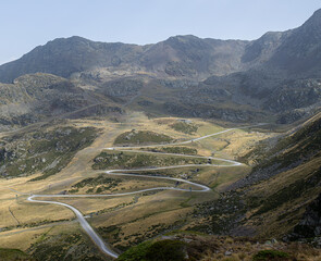 Zigzag road that goes up between the mountains to Puig Arcalis in Andorra