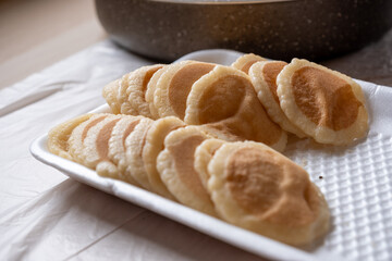 Qatayef plate ready to be filled and stuffed on wooden table
