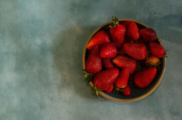 fresh strawberries in cedramica container with natural background