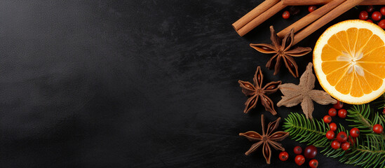 Two symmetrical arrangements of Christmas spices like cinnamon and star anise, with a central orange slice, Christmas background, top view, with copy space