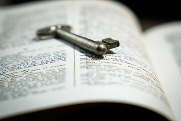 close up of an book with metal key 