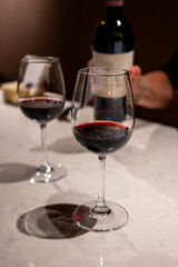 Tasting of red dry Saint-Emilion wine aged in French oak wooden barrels in cellar, Saint-Emilion wine making region, France, Bordeaux
