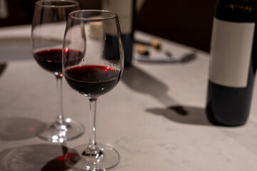 Tasting of red dry Saint-Emilion wine aged in French oak wooden barrels in cellar, Saint-Emilion wine making region, France, Bordeaux