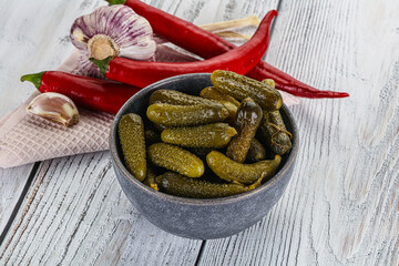 Marinated small cucumbers in the bowl