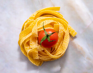 Pasta tagliatelle with tomatoes seen from above