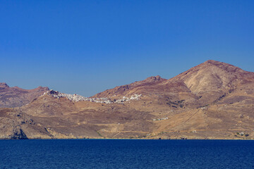 Coastal view with Chora village on the hill, Serifos island GR - 683539440