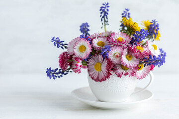 Summertime inspiration, colourful floral composition for Mother's or Women's day, anniversary, birthday. Greeting holiday card template with summer fresh bright daisy flowers in a white porcelaine mug
