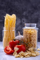 Whole spaghetti, bunches of tomatoes and garlic