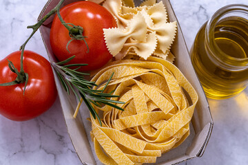 Pasta tagliatelle, tomatoes and rosemary leaves