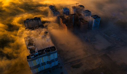 Ethereal Heights: Above the Fog with High Buildings as Beacons