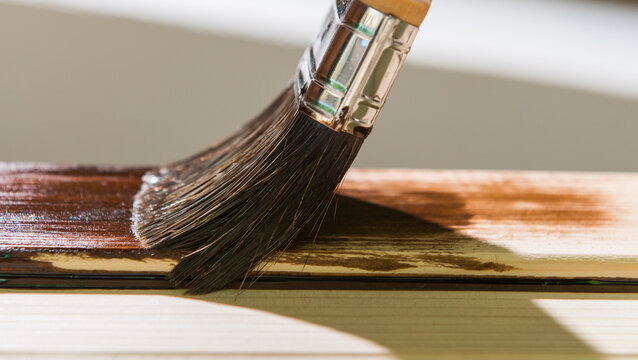 Maintaining of wooden surfaces with  protective paint.