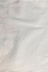 Eco-friendly natural material. White cotton fabric slightly wrinkled texture.