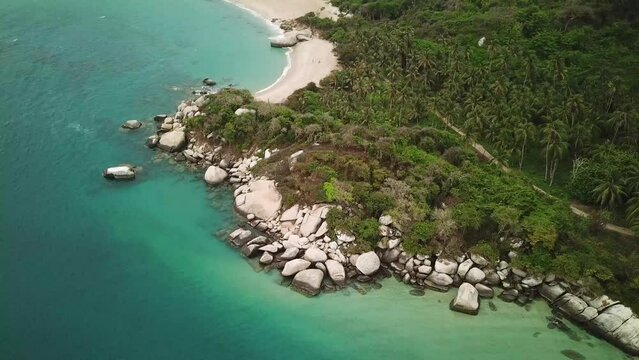 Aerial drone footage of the paradise nature in Tayrona National Park, Colombia, Latin America. Turquoise sand beach and white rocks of Caribbean coast. High quality 4k footage.