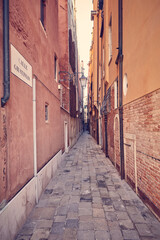 Fototapeta na wymiar Old narrow street in Venice city, Italy