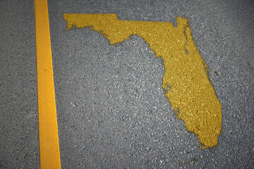 yellow map of florida state on asphalt road near yellow line.