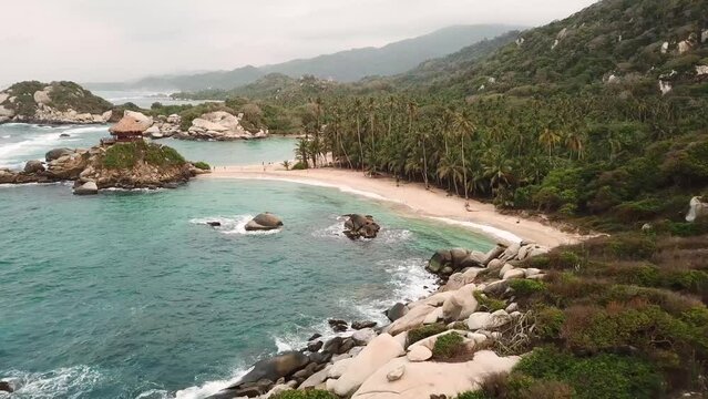 Aerial drone footage of the paradise nature in Tayrona National Park, Colombia, Latin America. Cabo San Juan kiosk, Turquoise sand beach and white rocks of Caribbean coast. High quality 4k footage.
