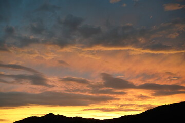 The mountains and the sky, the sunset and the clouds. 
clouds moving in the wind.