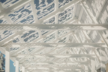 Frozen grate in winter. lattice with frost on the background of the blue sky. grid covered with...