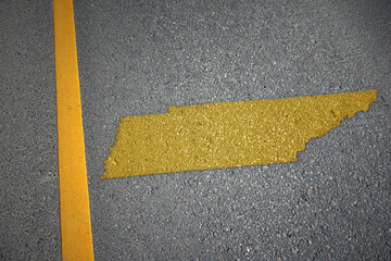 yellow map of tennessee state on asphalt road near yellow line.