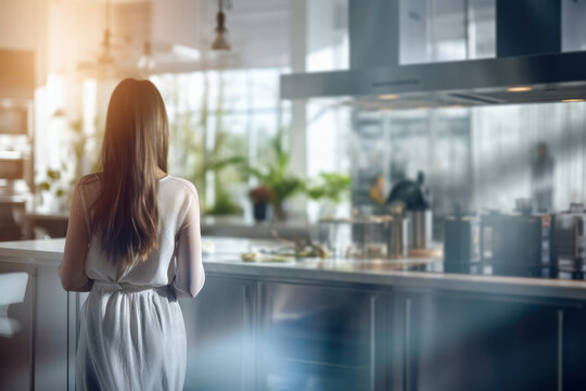 A woman, clad in a white blouse and dress, gazes down at her culinary creation in the kitchen, captivated by the art of cooking and food preparation.
