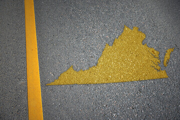 yellow map of virginia state on asphalt road near yellow line.