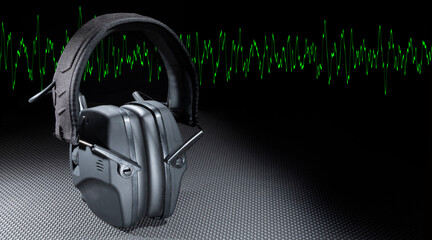 Green sine wave and protective headphones