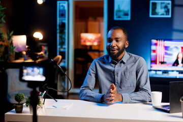 African american streamer doing live broadcast talking to audience about recent news headlines....