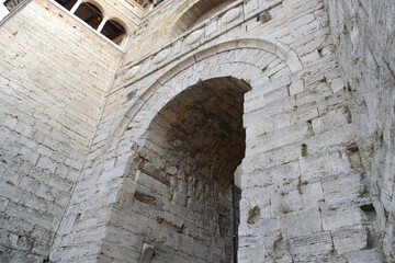 Etruscan Arch in Perugia, Italy Ancient stone archway in weathered white limestone, textured surface, Romanesque, dramatic perspective, historic ruin, isolated, perfect for travel, history