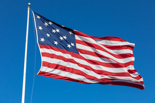 USA Flag Waving in Blue Background. Clear Blue Sky. American Wave Flag