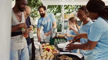 Group of volunteers devotedly packaging food to be distributed to the less fortunate. Poor homeless...