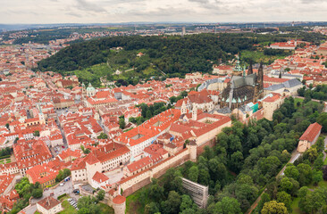 Obraz premium Prague Old Town with St. Vitus Cathedral and Prague castle complex with buildings revealing architecture from Roman style to Gothic 20th century. Prague, capital city of the Czech Republic. Drone
