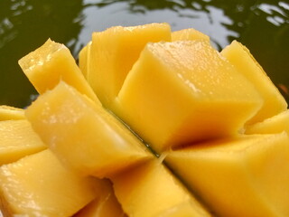 ripe mango that has been cut in half. exotic