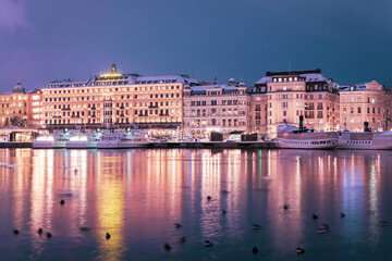 Fototapeta na wymiar View of illuminated buildings at waterfront