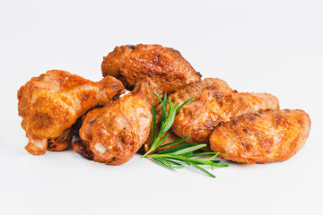 Chicken wings fried until half cooked, semi-finished product with fresh herbs on a white background. Fast food. Fast cooking.Quick cooking at home. Copy space.Fast homemade food.Raw chicken meat.