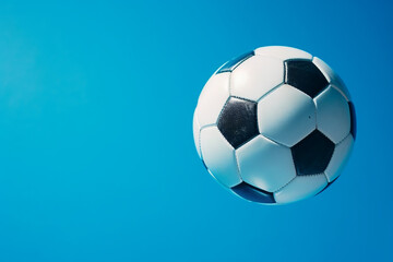 Fototapeta premium Striking Soccer Ball in Goal on Vibrant Blue Background - Created with Generative AI Tools