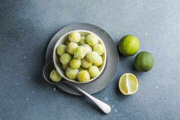 Grapes in sugar frozen. Methods for freezing grapes: bulk frozen, frozen with sugar and frozen puree on a light gray background. Healthy homemade preparations