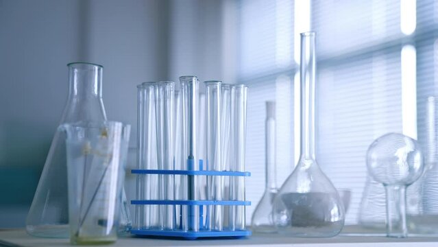 Set of test tubes and beakers on the table. Empty glassware in the medical laboratory. Close up.