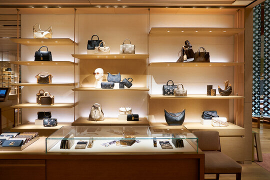 SINGAPORE - NOVEMBER 07, 2023: bags on display inside Louis Vuitton store in Singapore Changi Airport. Louis Vuitton is a French luxury fashion house.
