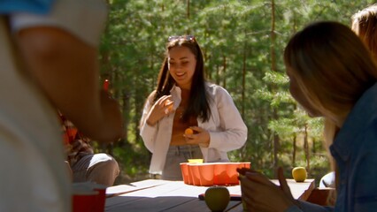 Young people play beer pong. Stock footage. Game for group of friends with glasses of alcohol and...