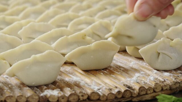 making dumplings in the kitchen. traditional food raw dimplings