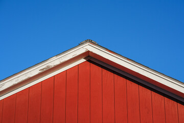 close up on roof top of red wooden house
