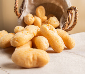 Traditional Brazilian starch biscuit falling from a basket into table